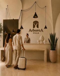 a man and a woman with a suitcase in a store at Villa ArboreA in Squinzano +46 photos