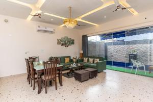 a living room with a table and a couch at Velmora Stay Premium Luxury Villa with Private Pool in Amritsar