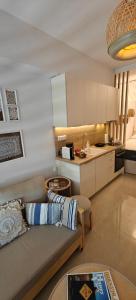 a living room with a couch and a kitchen at VALEXX luxury studio in Perea