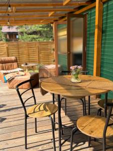 a patio with two tables and chairs on a deck at Przystanek Natura in Gorczyca