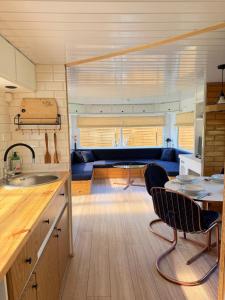 a kitchen and living room with a table and chairs at Przystanek Natura in Gorczyca +2 photos