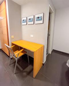 a wooden table and a chair in a room at Hotel Centro in Cali
