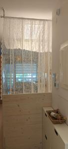 a kitchen with a window with a white curtain at VALEXX luxury studio in Perea +49 photos