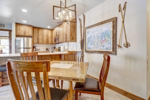 a kitchen and dining room with a wooden table and chairs at CS110 Copper Springs in Copper Mountain +40 photos