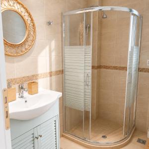 a bathroom with a shower and a sink at Schinos Salty Studio in Vathí