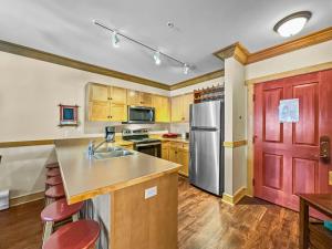 a kitchen with a sink and a refrigerator at CS129 Copper Springs in Copper Mountain