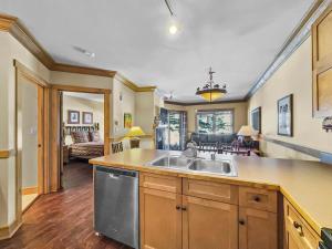 a kitchen with a sink and a living room at CS129 Copper Springs in Copper Mountain