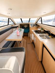a view of the inside of a boat with a table and a sink at bahati blue riviera in Mandelieu-La Napoule