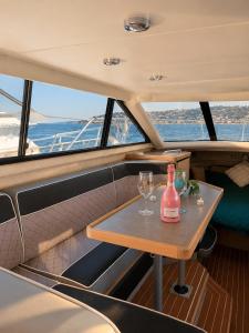 a table in the back of a boat with a bottle and glasses at bahati blue riviera in Mandelieu-La Napoule +11 photos