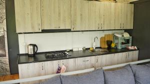 a kitchen with wooden cabinets and a counter top at Jermuk gaden in Kechʼut