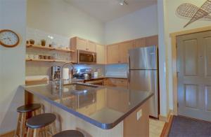 a kitchen with a sink and a refrigerator at CS407 Copper Springs in Copper Mountain