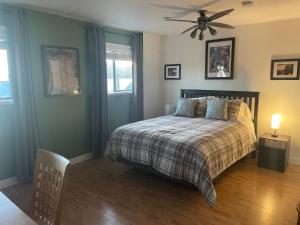a bedroom with a bed and a ceiling fan at Bayside Inn in Alert Bay