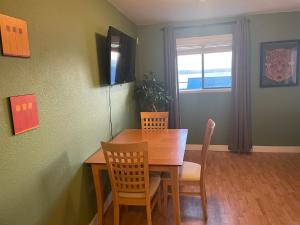 a dining room with a wooden table and chairs at Bayside Inn in Alert Bay