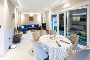 a dining room with a table and chairs and a couch at Villa Eterna in Tarčin