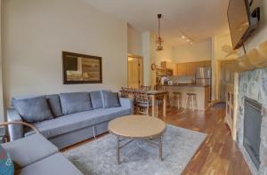 a living room with a blue couch and a kitchen at CS407 Copper Springs in Copper Mountain
