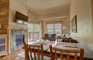 a dining room with a table and a fireplace at CS407 Copper Springs in Copper Mountain +27 photos