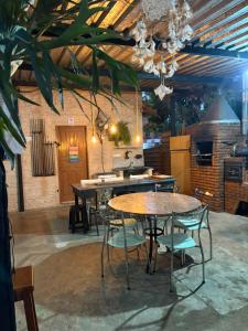 a kitchen with tables and chairs in a room at Casa Beira Rio in Araras