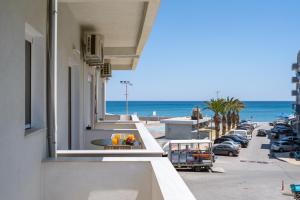 a view of the beach from the balcony of a building at Agathe Apartment in Ierapetra
