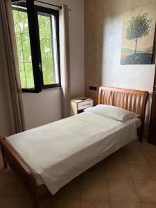 a bed in a bedroom with a window at Agriturismo Terra Del Mare in Fossalòn +24 photos