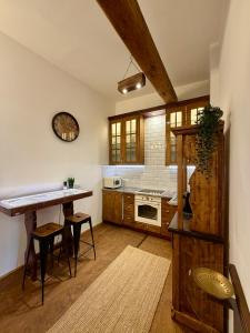 a kitchen with a table and a counter top at Malom Loft Apartman in Veszprém