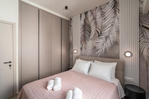 a bedroom with a bed with white towels on it at Agathe Apartment in Ierapetra