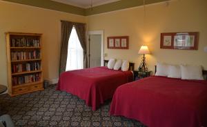 a hotel room with two beds and a window at Historic Plaza Hotel in Las Vegas