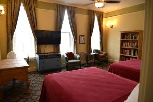 a hotel room with two beds and a flat screen tv at Historic Plaza Hotel in Las Vegas