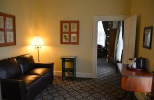 a living room with a couch and a table and a lamp at Historic Plaza Hotel in Las Vegas