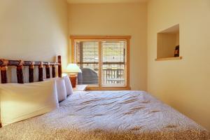 a bedroom with a large bed and a window at CS425 Copper Springs in Copper Mountain