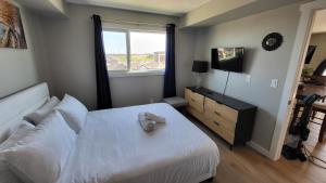 a bedroom with a white bed and a window at Heavenly Rest by JC in Edmonton