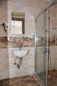 a bathroom with a sink and a shower at KENT HOTEL Didim in Didim +24 photos