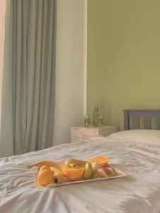 a tray of fruit sitting on top of a bed at Guest House Germani in Telavi +3 photos