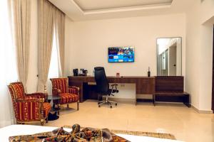 a hotel room with a desk and a mirror at Treal Hotels & Suites in Abeokuta