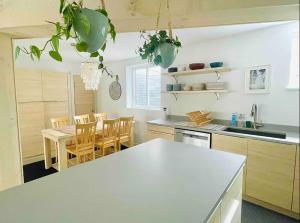 a kitchen with a table and chairs and a kitchen with a counter at The Bunker - Ski Shuttle Shopping Center in Stowe