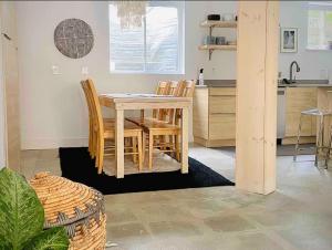 a kitchen with a table and chairs in a room at The Bunker - Ski Shuttle Shopping Center in Stowe