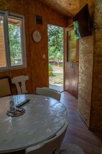a dining room with a table and chairs at Lakeside Cabin in Jablanica
