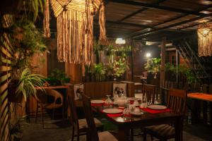 a dining room with a table and chairs and plants at Machcha Lodge Sigiriya in Sigiriya