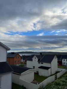 a group of white houses in a residential neighborhood at Arctic View Apartament Vardø in Vardø