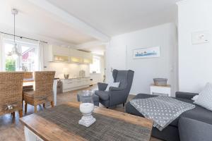 a living room with a couch and a table at Buhne 3 in Grömitz