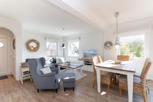 a living room with a couch and a table at Buhne 3 in Grömitz +29 photos