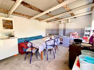 a kitchen with a table and chairs in a room at Alaman Guest House in Kaji-Say