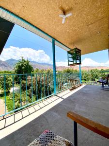 a balcony with a view of the mountains at Alaman Guest House in Kaji-Say +6 photos