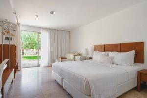 a white bedroom with a large bed and a window at Flow Datca Surf & Beach Hotel in Datca +70 photos