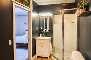 a bathroom with a shower and a sink at Launchpoint Lodge in Lincoln +84 photos