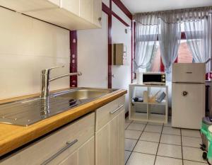 a kitchen with a sink and a refrigerator at Relax Apartment Backnang in Backnang
