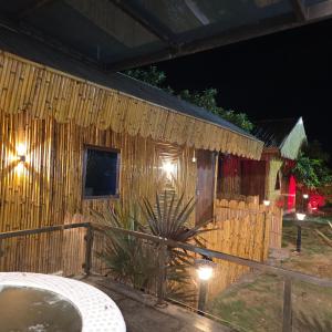 a wooden house with a fence and a table at Rajashree Multipurpose Resort in Solapur