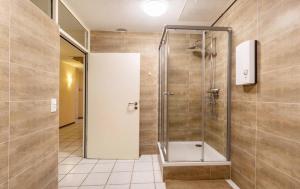a shower with a glass door in a bathroom at Relax Apartment Backnang in Backnang +17 photos