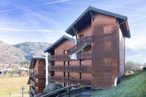 a large wooden building with balconies on a hill at 6 pers, proche pistes et commerces in Morillon