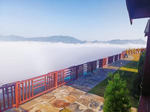 a balcony with a view of a body of water at IBP Estate in Rānīkhet +1 photo