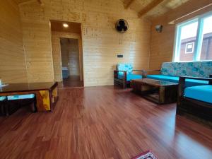 a large room with blue chairs and a table at IBP Estate in Rānīkhet